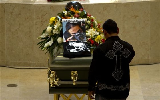 A man mourns in front of the coffin containing the body of Diario de Juarez newspaper photographer Carlos Santiago during his wake in the northern border city of Ciudad Juarez, Mexico, Saturday.